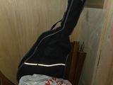 a guitar case sitting on top of a suitcase