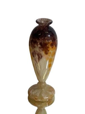 a glass vase sitting on a pedestal on a white background
