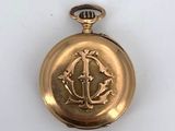 an image of a gold pocket watch on a white surface