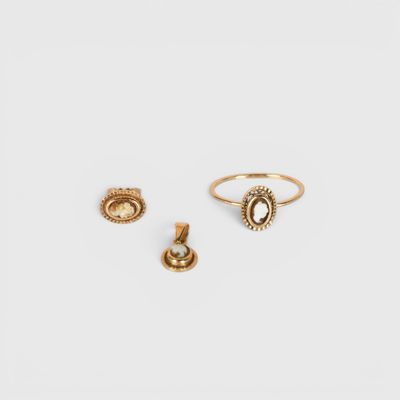 a set of three gold rings and a gold earring