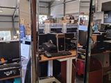 a large mirror in the middle of a room full of computer equipment