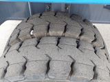 the tire of a truck with a flat tire on the ground