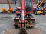 a picture of a red and black crane in a parking lot