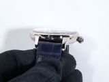 a person holding a watch in their hand on a white surface