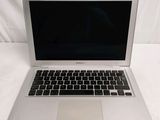 a silver laptop computer sitting on a white surface