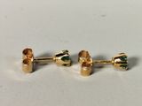 a pair of gold earrings with green stones on them