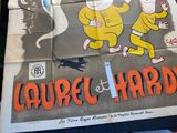 a poster for laurel and hardy on a table