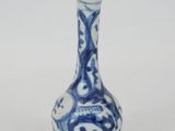 a small blue and white vase with a design on it
