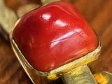 a close up of a keychain with a red object on it
