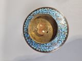 a blue and gold plate with a clock on it