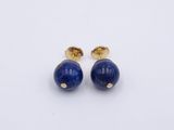 a pair of lapis stone stud earrings on a white background