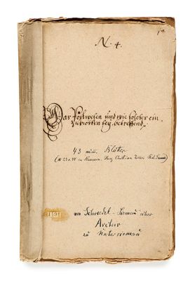 an old book with writing on it sitting on top of a table