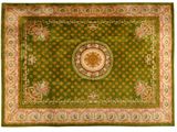 a green rug with a medallion on the center of it