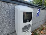 a white hand dryer sitting on the side of a building