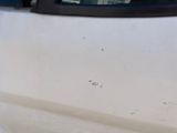 a white car that has a hole in the side of it