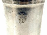 a silver cup with a handle that has a picture of a lion on it