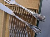 a lot of forks and spoons that are in a box