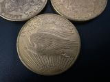 three coins sitting on top of each other on a blue surface