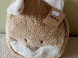 a small stuffed animal bag with a tag on it