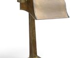 an image of a brass desk lamp with a roll of paper on it