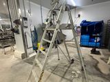 a ladder that is sitting in the middle of a room