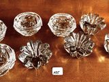six glass vases sitting on a table with a gold background