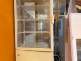 two refrigerators sitting on top of a counter in a kitchen
