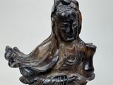 a statue of a woman holding a bird in her hand