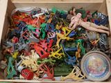 a wooden box filled with assorted plastic toys