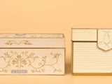 two small boxes sitting next to each other on a table