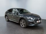 a grey audi qx parked in a showroom