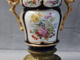 a vase that is sitting on a stand on a table