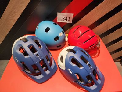 three helmets are sitting on a table with a price tag