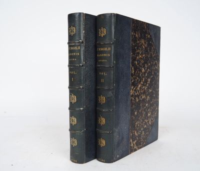 an old book sitting on top of a table next to a white wall