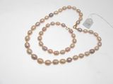 necklace and bracelet with pearls on a white surface
