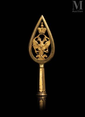 a close up of a gold spoon with a dragon on it