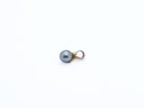 a close up of a single pearl on a white surface