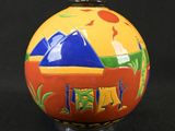 a colorful ball with a picture on it on a black background