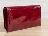 a close up of a red wallet on a wooden table