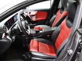 the interior of a car with red and black seats and a steering wheel