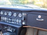 a dashboard of an old car with many gauges on it