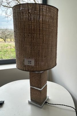 a lamp that is sitting on a table by a window