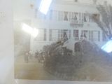 an old photo of a building with a horse and carriage in front of it