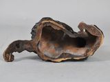 a small sculpture of a shell on a white surface