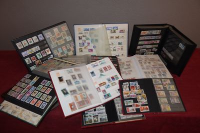 a lot of stamps on a table with a red table cloth