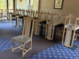 a room with a bunch of chairs and a table in it