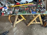 a lot of tools sitting on a workbench in a garage