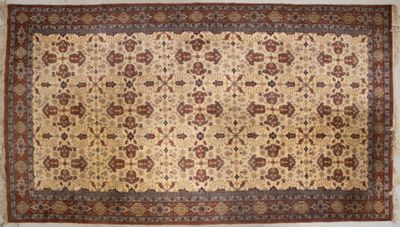 Grand tapis laine tisse main à fond beige.