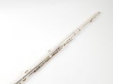 a silver flute on a white surface with a white background