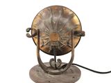 an old fashioned lamp that is sitting on a table